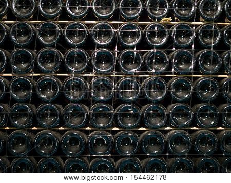 The rack with bottles of wine for aging in the cellar
