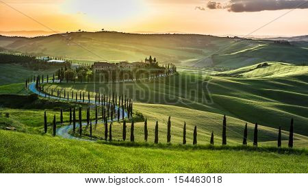 Sunset Over The Winding Road With Cypresses In Tuscany