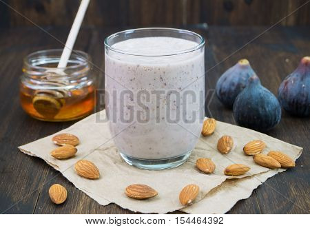 Honey almond fig smoothie. Healthy autumn fall smoothie on wooden background selective focus horizontal