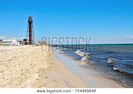 Old Lighthouse On The Beach Near The Sea. Lighthouse On The Coast Of The Island Dzharylgach.