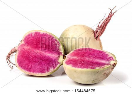 One whole and sliced watermelon radish isolated on white background.