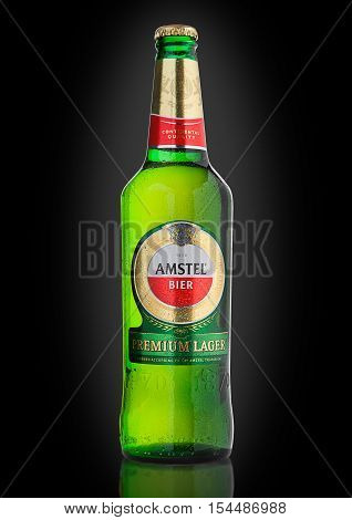 LONDON UNITED KINGDOM - NOVEMBER 01 2016: Cold bottle of Amstel Premium Lager on black background.Amstel is an internationally known brand of beer produced by Heineken International in Zoeterwoude Netherlands.