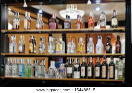 Blur Efferct Of Several Types Of Bottled Alcohol Are Displayed On Some Shelves In A Restaurant