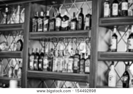 Blur Efferct Of Several Types Of Bottled Alcohol Are Displayed On Some Shelves In A Restaurant