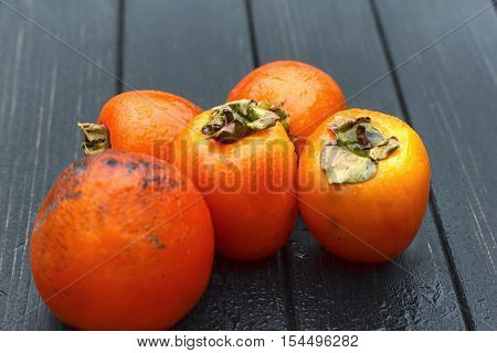 persimmon Fresh ripe persimmon on wooden table fruits on rustic table tropical fruit