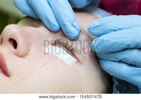 Woman on the procedure for eyelash extensions, eyelashes lamination
