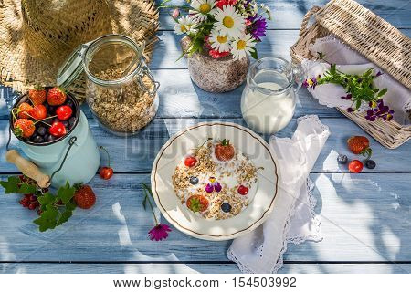 Summer breakfast in the garden on old wooden table