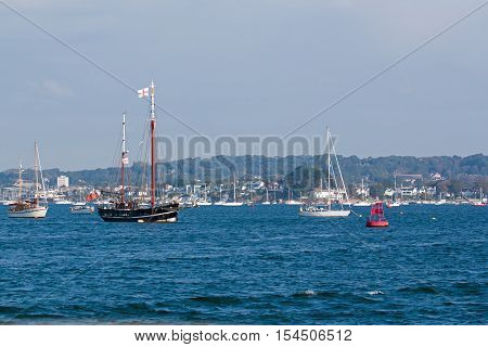 Sailing vessels and motor craft anchored in Poole Harbour Dorset England.