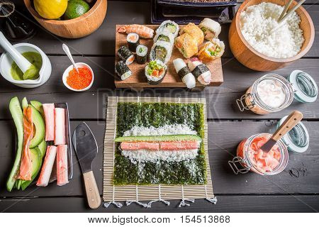 Table with ingredients for sushi on old wooden table