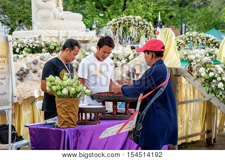 Bangkok, Thailand - December 5, 2015: Unidentified woman is selling lottery near Buddha statue in Sanam Luang Bangkok Thailand. Lottery is one of the favorite gambling entertainments in Thailand.