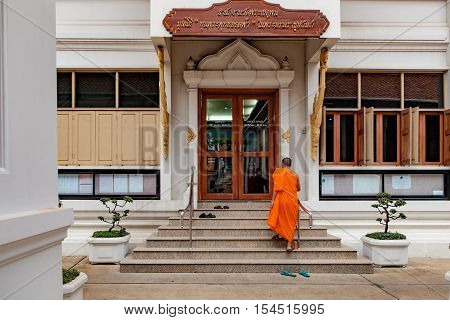 Bangkok, Thailand - December 7, 2015: Monk goes up the stairs of office building of Maha Chulalongkon Ratcha Witthayalai University. It is one of two public Buddhist universities in Thailand.