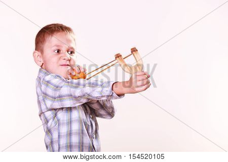 Young Boy Use Sling Shot Shoot Mandarine.