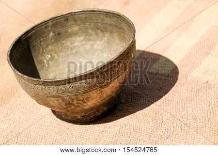 Selling old silver color metal cookware in bazaar