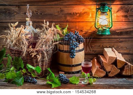 Grapes And Red Wine In A Demijohn
