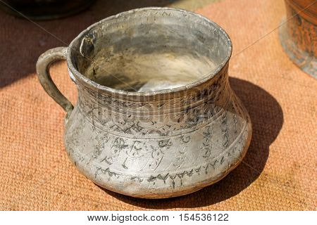 Selling old metal cookware in a market place
