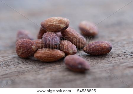 Raw almonds on wood.Golden almonds on wood background.