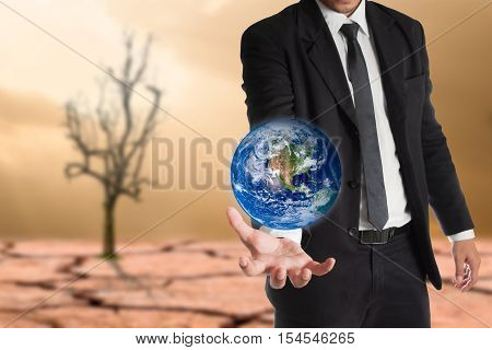 Businessman holds Earth in a hand global warming concept. Elements of this image are furnished by NASA
