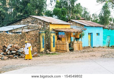 Axum Ethiopia - January 20 2016: A priest in front of the poor houses of the outskirts