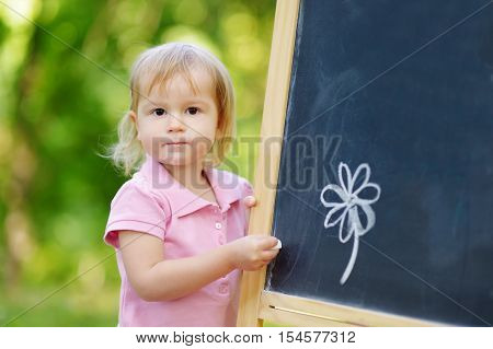 Adorable Toddler Drawing With A Chalk