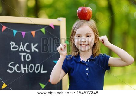Very Excited Little Schoolgirl By A Chalkboard