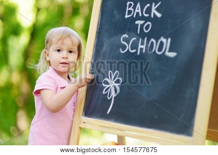Adorable little girl feeling excited about going to preschool for the first time