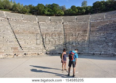 Epidavros Greece - Sept 23 2016: Tourists visit the ancient Theatre in Epidaurus built in 340 BC. This beautiful and best preserved theatre is on UNESCO World Heritage List since 1988