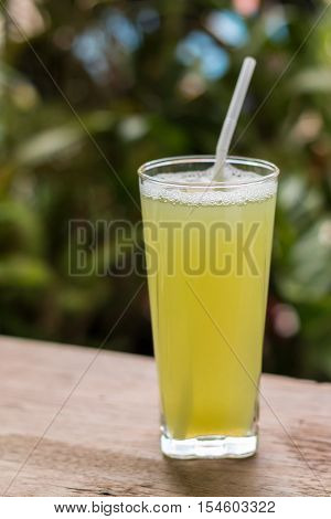 Sugarcane Juice With Piece Of Sugarcane On Wooden Background
