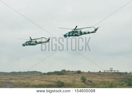 Zhitomir Ukraine - September 29 2010: A pair of Ukrainian Army Mi-24 attack helicopters in flight during military trainings - side view