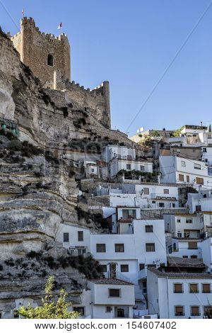 Alcala del Jucar Spain - October 29 2016: Side view of the village on top of limestone mountain is situated Castle of the 12TH century Almohad origin take in Alcala of the Jucar Albacete province Spain