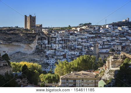 Alcala del Jucar Spain - October 29 2016: Panoramic view of the city on top of limestone mountain is situated Castle of the 12TH century Almohad origin take in Alcala of the Jucar Albacete province Spain