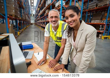 Portrait of warehouse manager and worker working together in warehouse office