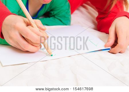 kids education and learning - hands of mother and child writing numbers