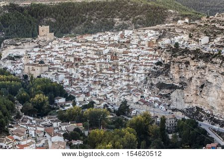 Alcala del Jucar Spain - October 29 2016: Panoramic view of the city on top of limestone mountain is situated Castle of the 12TH century Almohad origin take in Alcala of the Jucar Albacete province Spain