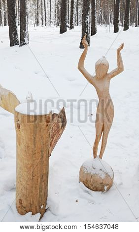 Irkutsk Region, Ru-Jan, 03 2015: Girl on the Ball. Park of wooden sculptures in Savvateevka Village