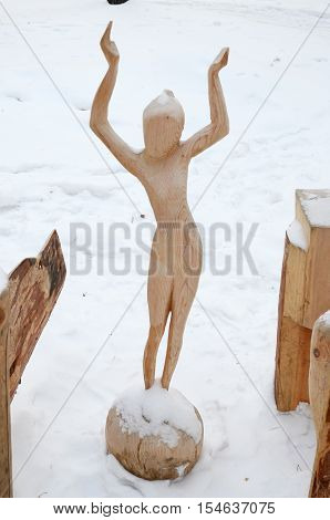 Irkutsk Region, Ru-Jan, 03 2015: Girl on the Ball. Park of wooden sculptures in Savvateevka Village