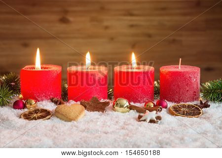 Three Advent Candles Lit In Snow