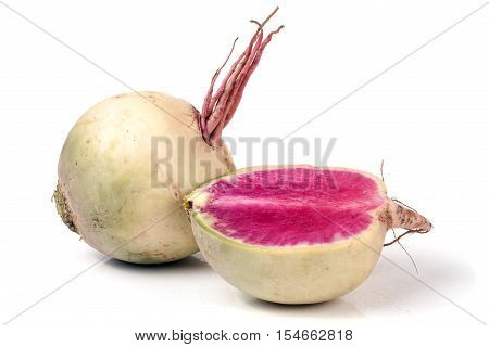 One whole and sliced watermelon radish isolated on white background.