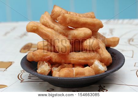 Close up of ready served as Patongko (deep-fried dough stick) . Selective focus.