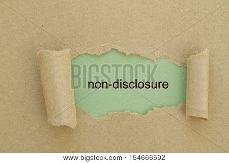 Non-Disclosure word written under torn paper .