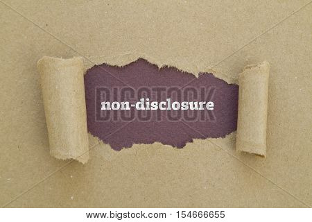 Non-Disclosure word written under torn paper .