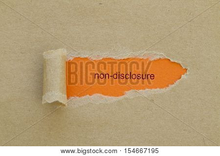Non-Disclosure word written under torn paper .