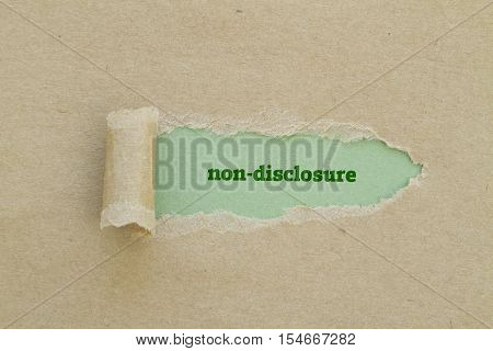 Non-Disclosure word written under torn paper .