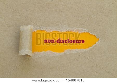 Non-Disclosure word written under torn paper .