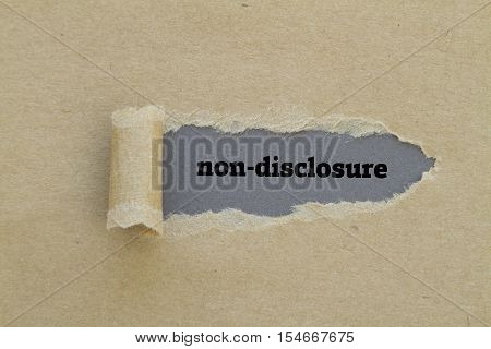 Non-Disclosure word written under torn paper .