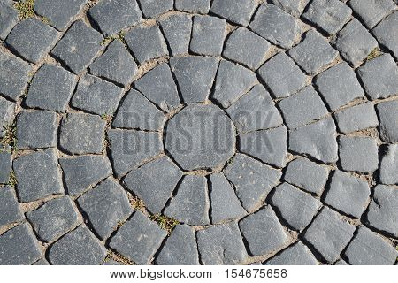 Old cobblestone pavement of the round texture