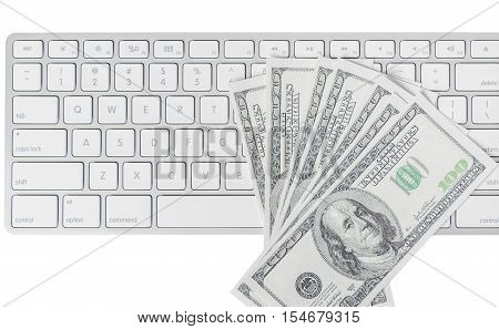 US hundred dollar bills with white computer keyboard isolated on white background
