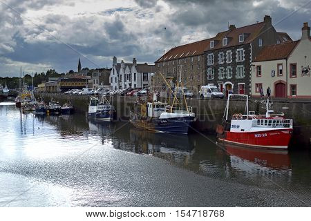 Boats and houses in Eyemouth old fishing town in Scotland UK. 07.08.2015