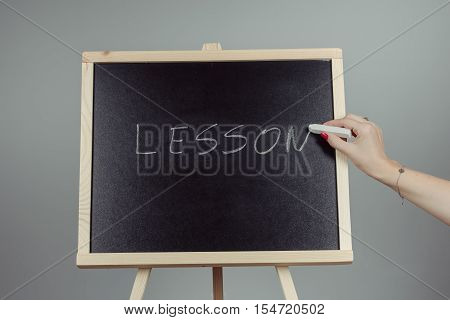 Lesson Written In White Chalk On A Black Chalkboard