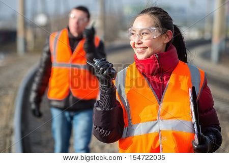 Man and a woman railroad workers maintaing railway