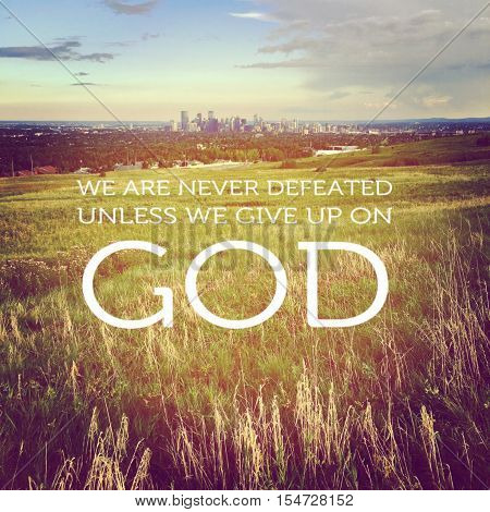 Inspirational quote. We are never defeated unless we give up on God.  Lighting and Instagram effects.